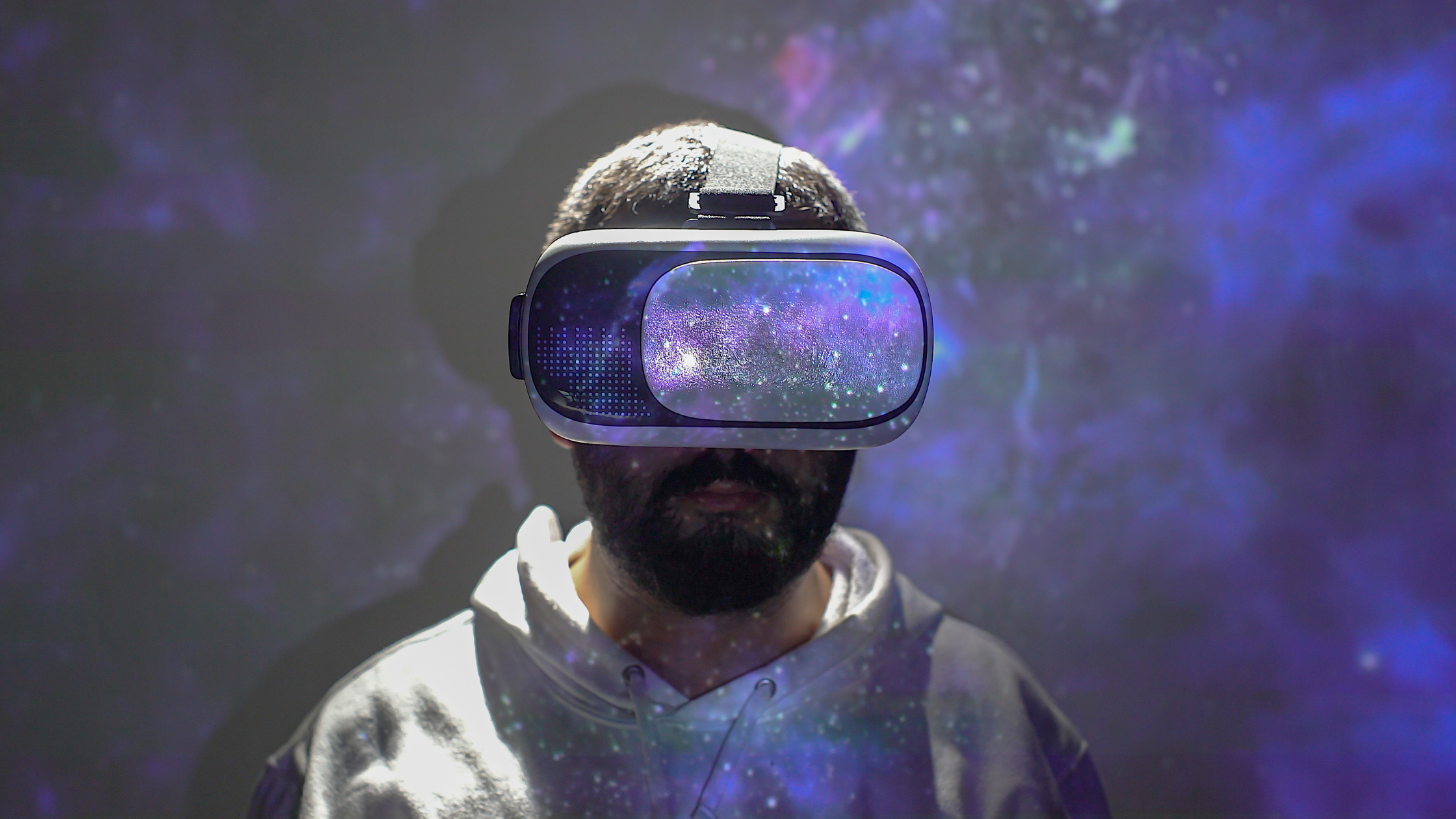 man in vr headset with galaxy reflected