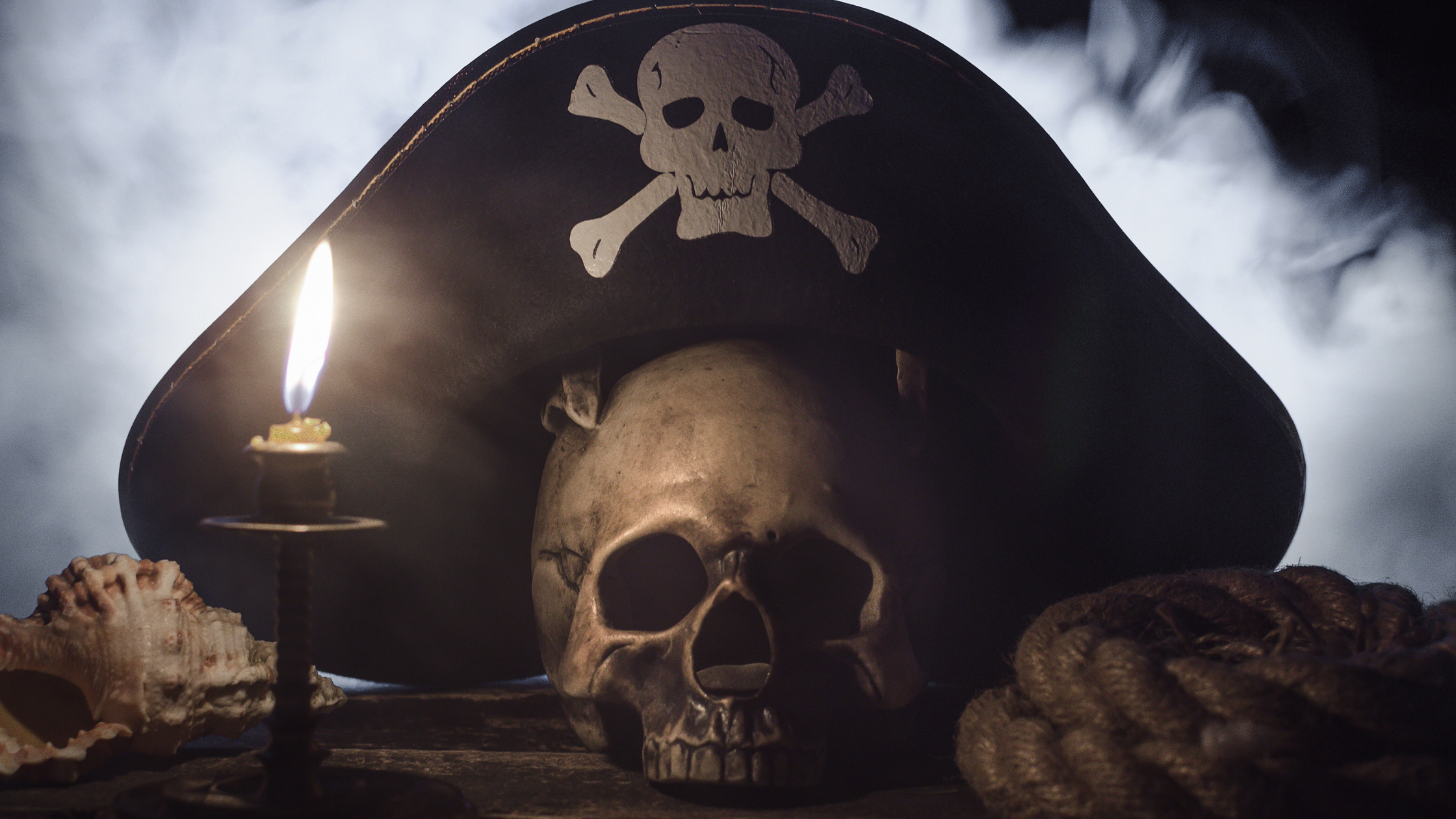 skull wearing pirate hat and candle