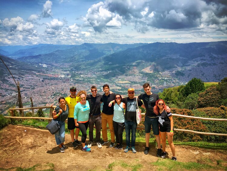 Group of people standing together with a scenic mountain view behind them